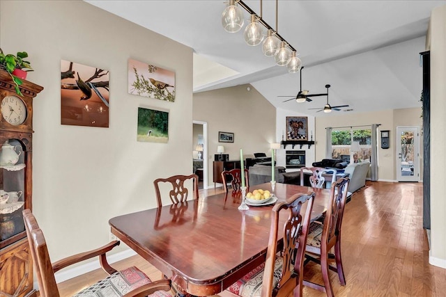 355 Old Line Ave, Exeter, CA 93221 - dining space with baseboards, lofted ceiling, a ceiling fan, wood finished floors, and a fireplace