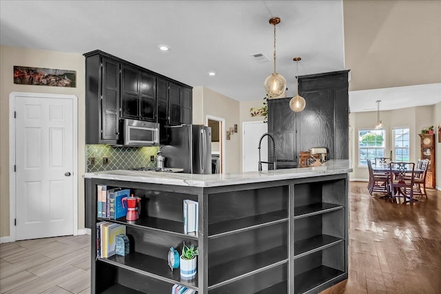355 Old Line Ave, Exeter, CA 93221 - kitchen featuring visible vents, dark cabinetry, wood finished floors, open shelves, and appliances with stainless steel finishes