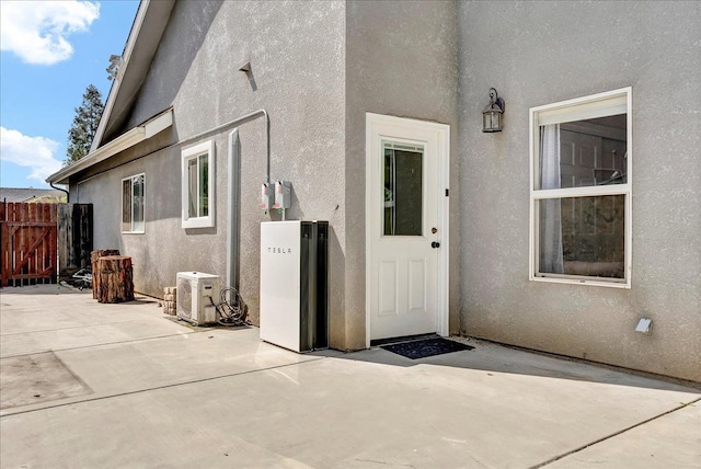 355 Old Line Ave, Exeter, CA 93221 - view of exterior entry featuring ac unit, a patio, stucco siding, and fence