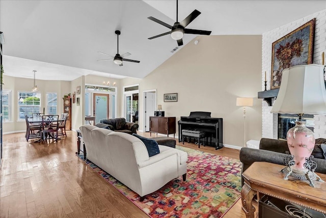355 Old Line Ave, Exeter, CA 93221 - living room with visible vents, a ceiling fan, light wood-type flooring, baseboards, and high vaulted ceiling
