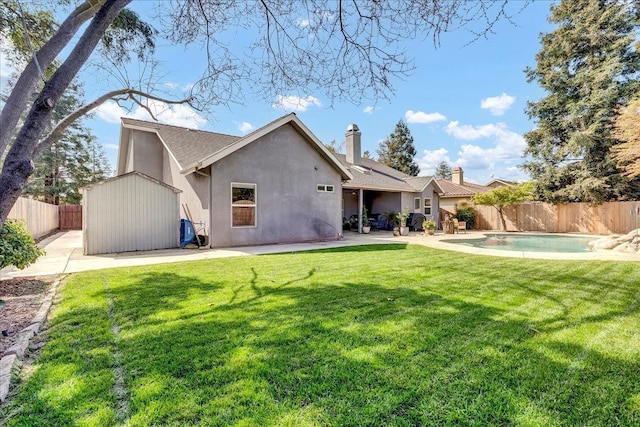 355 Old Line Ave, Exeter, CA 93221 - back of property featuring a yard, a patio area, a fenced backyard, and stucco siding