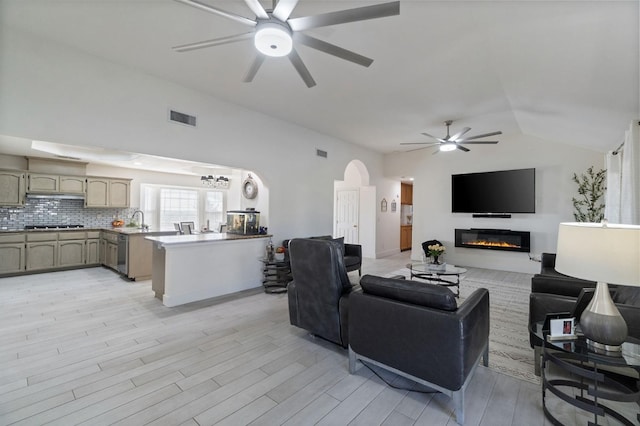 18294 Rd 27, Madera, CA 93638 - living area with light wood-style floors, lofted ceiling, visible vents, arched walkways, and ceiling fan