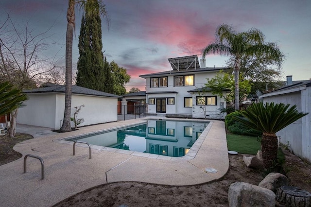 655 E Normal Ave, Fresno, CA 93704 - back of house with a patio area, an outdoor pool, and stucco siding