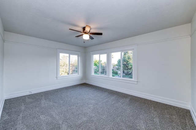 655 E Normal Ave, Fresno, CA 93704 - unfurnished room featuring dark carpet, baseboards, and healthy amount of natural light