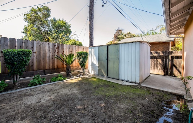 view of shed with a fenced backyard