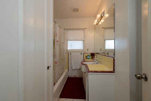 full bath with shower / tub combo, vanity, and visible vents