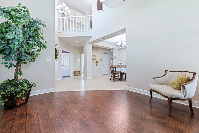 1110 Minarets Ave, Clovis, CA 93611 - entryway featuring a chandelier, wood-type flooring, baseboards, a ceiling fan, and a high ceiling