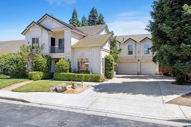 1110 Minarets Ave, Clovis, CA 93611 - view of front facade featuring a tiled roof, a garage, driveway, and stucco siding