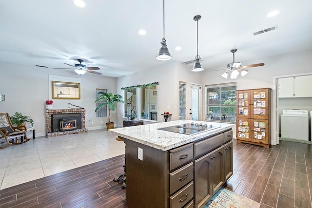 1110 Minarets Ave, Clovis, CA 93611 - kitchen with ceiling fan, black electric cooktop, washer / dryer, dark brown cabinets, and recessed lighting
