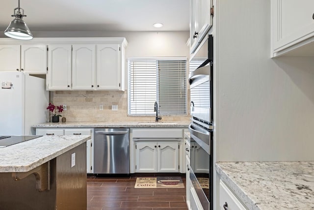 1110 Minarets Ave, Clovis, CA 93611 - kitchen with stainless steel dishwasher, a sink, black electric cooktop, wood tiled floors, and white cabinets