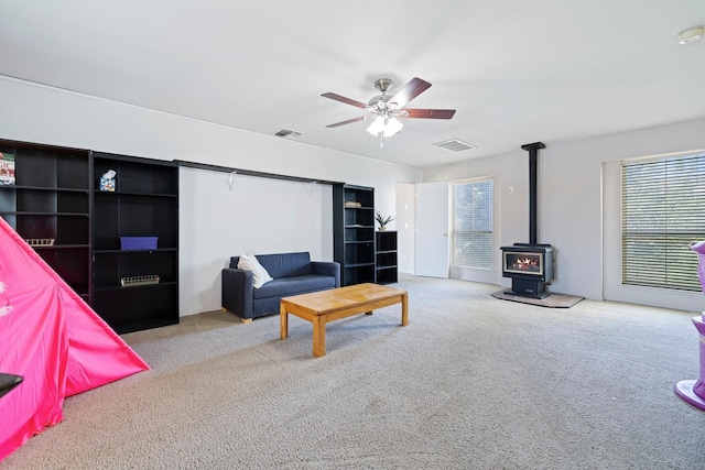 1110 Minarets Ave, Clovis, CA 93611 - carpeted living area with a wood stove and a ceiling fan