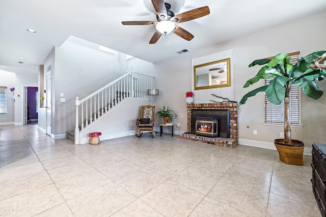 1110 Minarets Ave, Clovis, CA 93611 - tiled living room with stairs, ceiling fan, recessed lighting, baseboards, and a brick fireplace