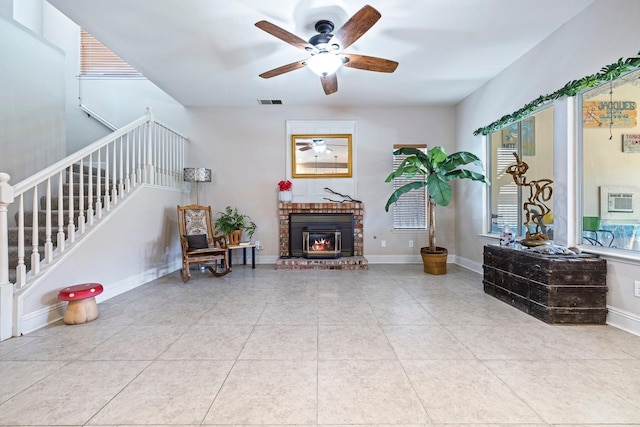 1110 Minarets Ave, Clovis, CA 93611 - tiled living room featuring stairs, ceiling fan, and a brick fireplace