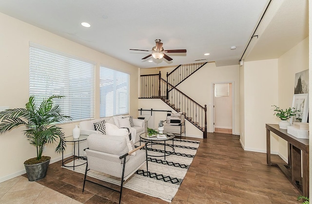 living area with stairway, a ceiling fan, wood finished floors, and recessed lighting