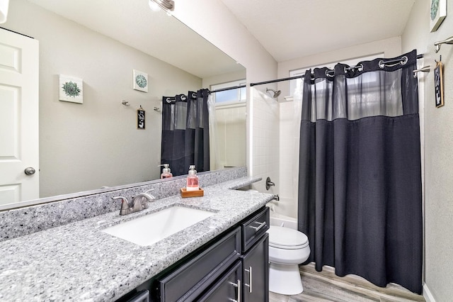 bathroom featuring shower / bath combination with curtain, wood finished floors, toilet, and vanity
