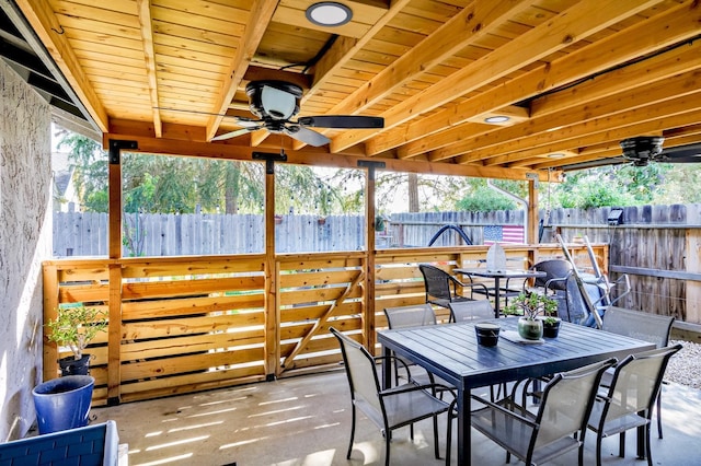 view of patio / terrace featuring fence, outdoor dining area, and ceiling fan