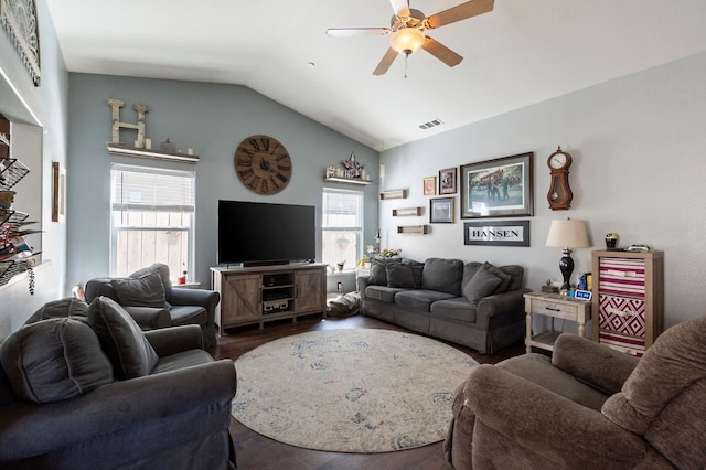 living area featuring dark wood-style floors, vaulted ceiling, a ceiling fan, and visible vents