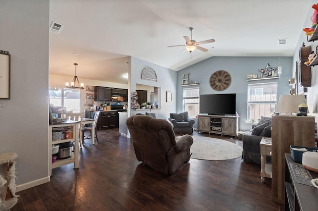living room with ceiling fan with notable chandelier, visible vents, vaulted ceiling, and plenty of natural light