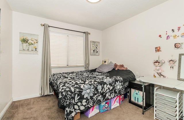 bedroom with baseboards and carpet flooring