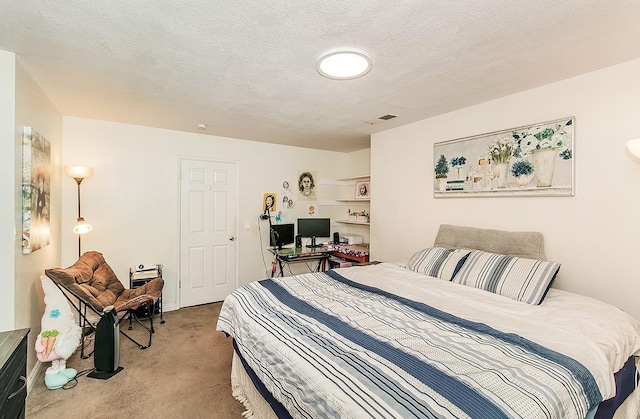 bedroom featuring light colored carpet, a textured ceiling, and visible vents