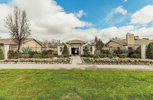 view of front of property featuring a residential view, fence private yard, and a front lawn