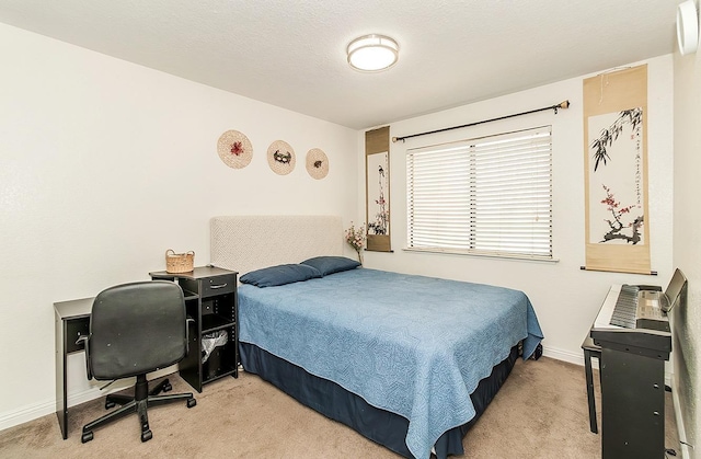 bedroom with baseboards and light colored carpet