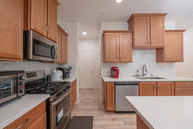 4865 E Alexander Ave, Fresno, CA 93725 - kitchen featuring stainless steel appliances, recessed lighting, backsplash, and light countertops