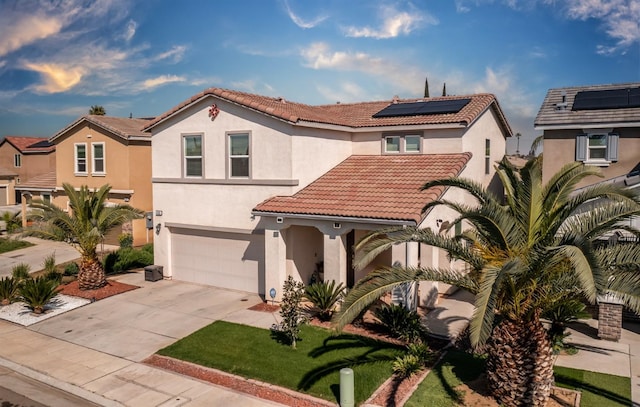 4865 E Alexander Ave, Fresno, CA 93725 - mediterranean / spanish-style home with stucco siding, a tiled roof, solar panels, a garage, and driveway