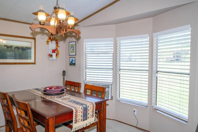 dining space featuring crown molding, carpet floors, a notable chandelier, and vaulted ceiling
