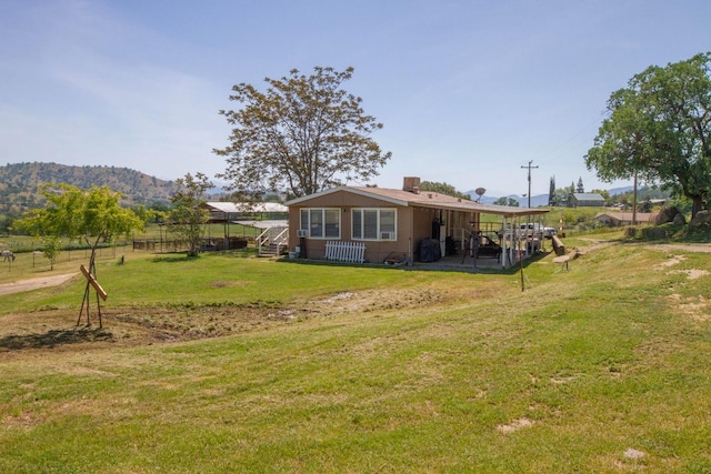 back of property featuring a lawn