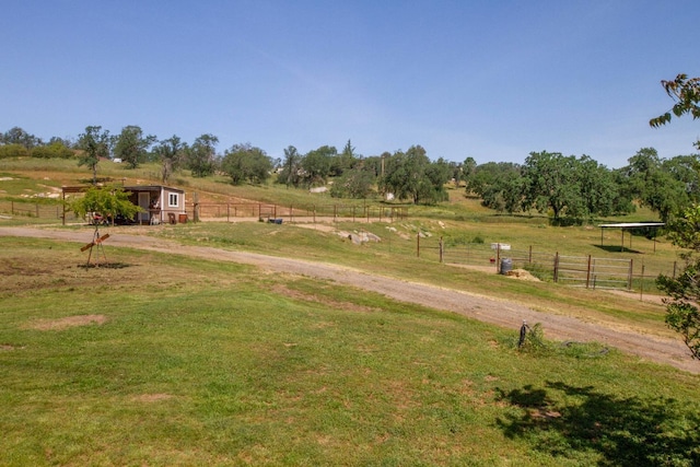 exterior space featuring fence and a rural view