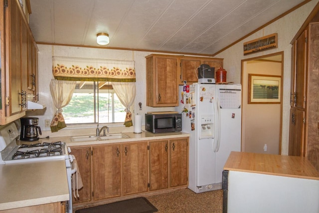 kitchen with white appliances, brown cabinetry, a sink, light countertops, and lofted ceiling