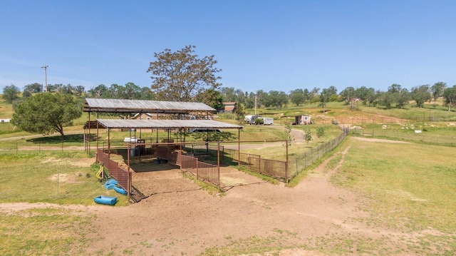 exterior space featuring an outbuilding, an exterior structure, and a rural view