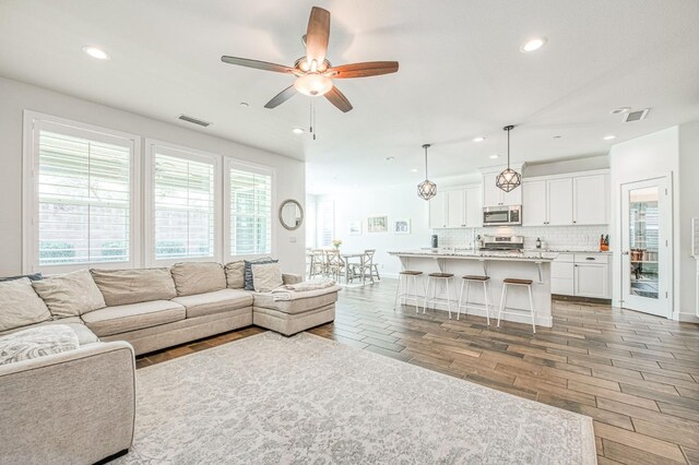 408 Grant Ave W, Madera, CA 93636 - living area with recessed lighting, visible vents, and wood finished floors