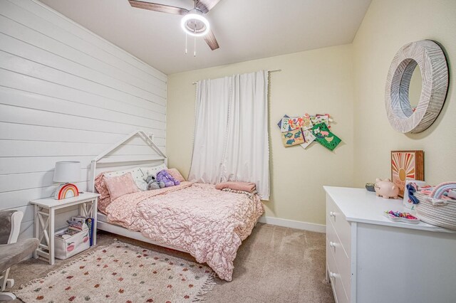 408 Grant Ave W, Madera, CA 93636 - bedroom with baseboards, a ceiling fan, wood walls, and light colored carpet