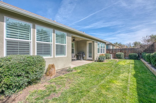 408 Grant Ave W, Madera, CA 93636 - rear view of property with a ceiling fan, a fenced backyard, a yard, a patio, and stucco siding