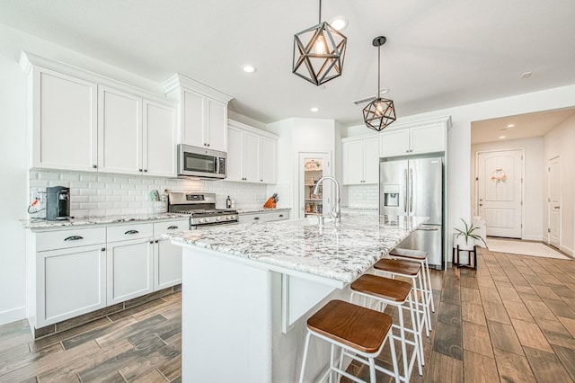 408 Grant Ave W, Madera, CA 93636 - kitchen with white cabinetry, appliances with stainless steel finishes, backsplash, and dark wood-style floors