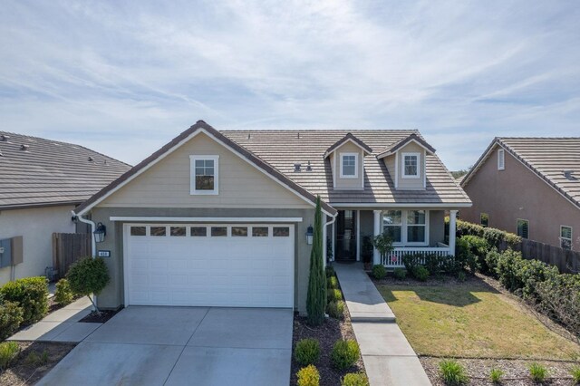 408 Grant Ave W, Madera, CA 93636 - traditional home with a garage, fence, covered porch, a front yard, and concrete driveway