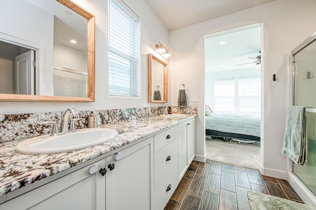 408 Grant Ave W, Madera, CA 93636 - full bathroom featuring double vanity, a sink, wood tiled floor, and a shower stall