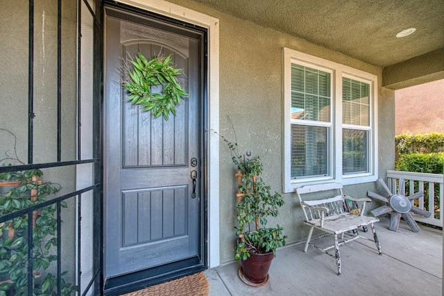 408 Grant Ave W, Madera, CA 93636 - doorway to property featuring stucco siding and a porch