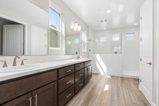 256 Huckleberry Ln S, Madera, CA 93636 - bathroom featuring visible vents, a sink, walk in shower, and wood finished floors