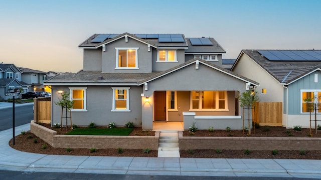 256 Huckleberry Ln S, Madera, CA 93636 - traditional-style home with fence, stucco siding, a tiled roof, a porch, and solar panels
