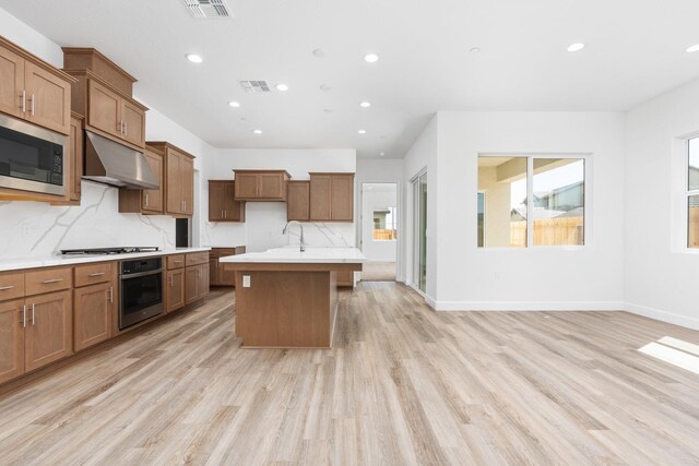 276 Huckleberry Ln S, Madera, CA 93636 - kitchen featuring brown cabinetry, recessed lighting, appliances with stainless steel finishes, and under cabinet range hood