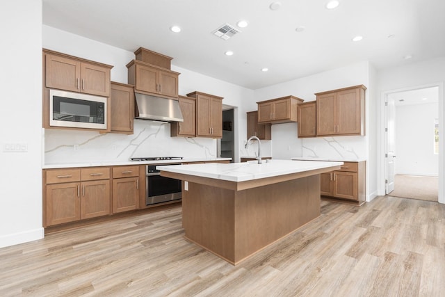 276 Huckleberry Ln S, Madera, CA 93636 - kitchen featuring visible vents, brown cabinetry, stainless steel oven, built in microwave, and under cabinet range hood
