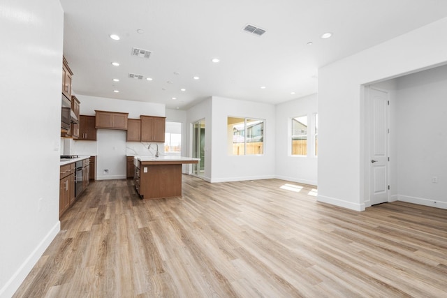 276 Huckleberry Ln S, Madera, CA 93636 - kitchen featuring light countertops, recessed lighting, open floor plan, light wood-type flooring, and visible vents