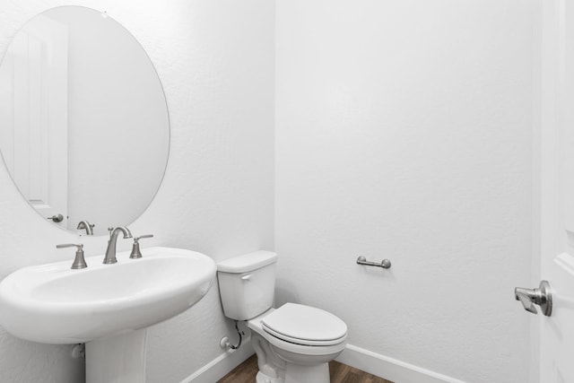 276 Huckleberry Ln S, Madera, CA 93636 - bathroom with toilet, baseboards, a sink, and wood finished floors