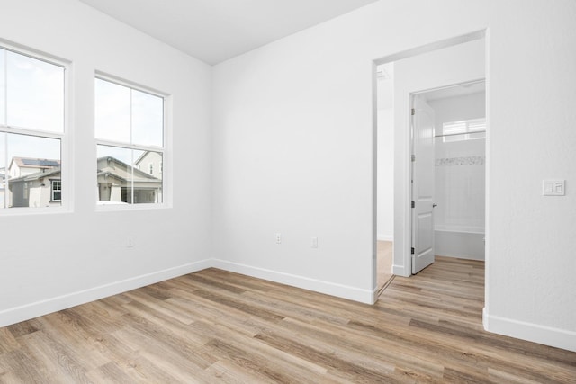 276 Huckleberry Ln S, Madera, CA 93636 - unfurnished bedroom with baseboards, light wood-style flooring, and a spacious closet