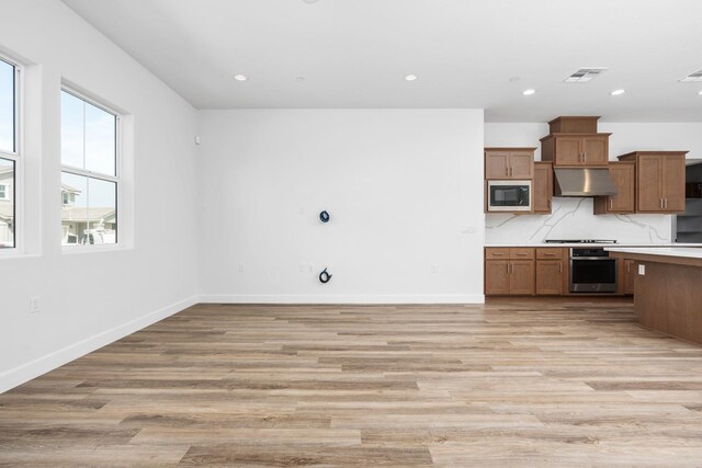 276 Huckleberry Ln S, Madera, CA 93636 - kitchen featuring oven, light countertops, built in microwave, under cabinet range hood, and stovetop