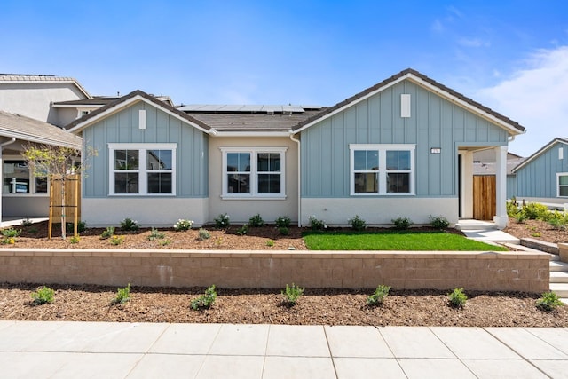 276 Huckleberry Ln S, Madera, CA 93636 - ranch-style home with board and batten siding, solar panels, and a tile roof