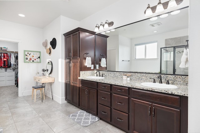 3887 N Condor Ct, Sanger, CA 93657 - bathroom featuring a shower stall, a walk in closet, double vanity, and tile patterned flooring